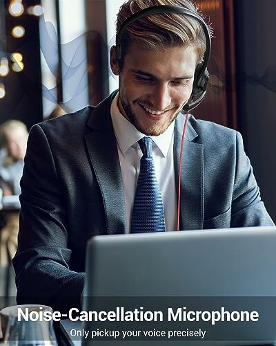 Businessman using a noise-cancellation headset with a laptop.