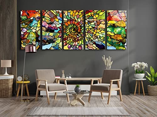 Colorful stained glass wall art in a modern living room with chairs and a lamp.