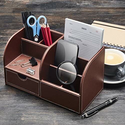 Leather desk organizer with office supplies and gadgets.