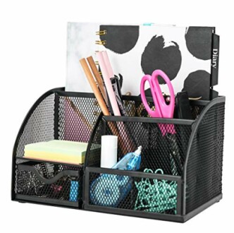 Mesh desk organizer with office supplies including pens, scissors, and notebooks.