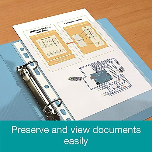 Binder with a document showing diagrams on a desk.