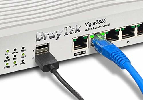 Close-up of DrayTek Vigor2865 VDSL2 Security Firewall router with connected cables.