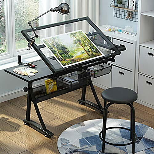 Modern drafting table with art supplies and stool in a bright room.