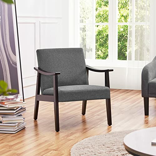 Modern gray armchair in a bright room with wooden floor and large windows