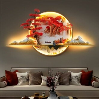 Illuminated circular wall art with red trees and mountains above a sofa.