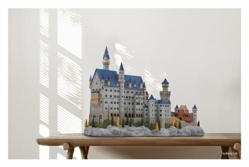 Model of Neuschwanstein Castle on a wooden table.