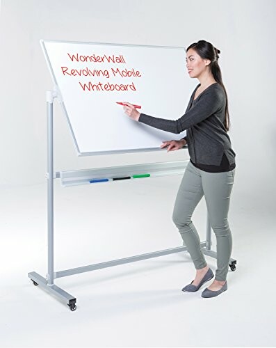 A woman writing on a revolving mobile whiteboard.