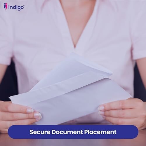 Person holding an open envelope with document