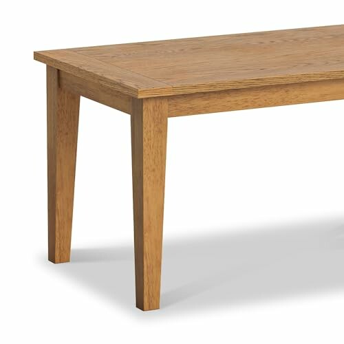 Corner of a wooden dining table with square legs