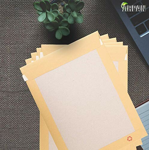 Stack of yellow envelopes on a desk with a plant and laptop corner visible